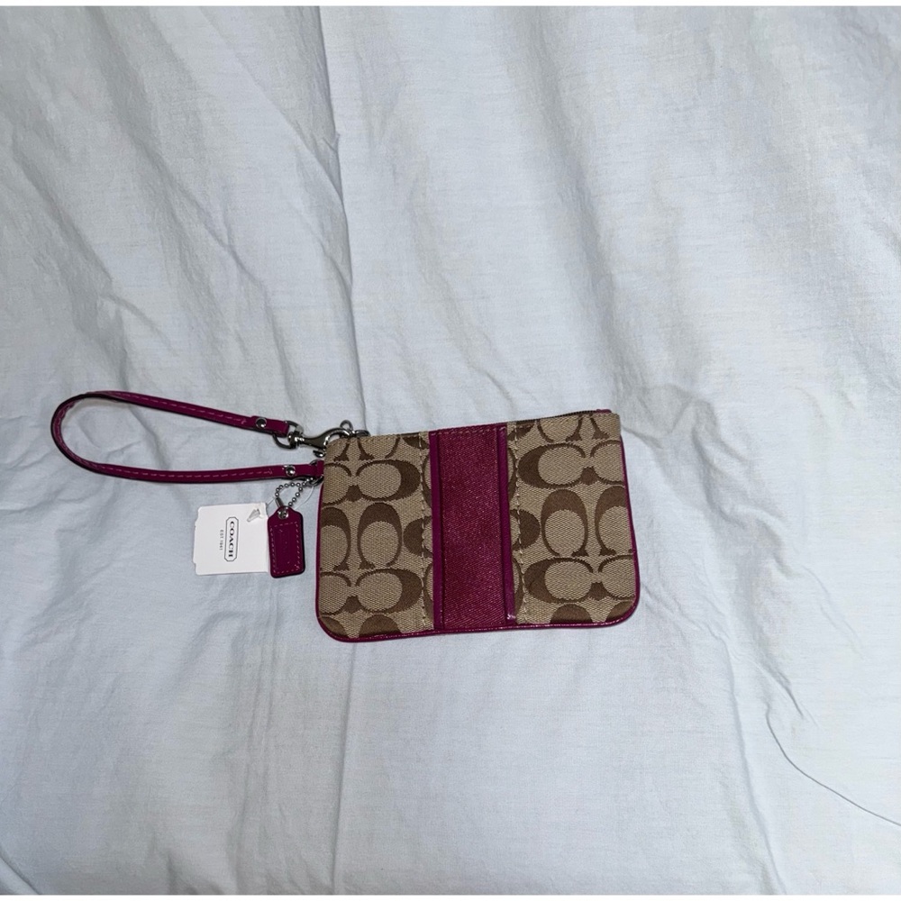 NWT Coach wristlet signature C stripe SV/khaki/passion berry. Never used.